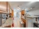Kitchen featuring granite countertops, wood cabinetry, stainless steel trash can, and tile flooring at 3160 Santa Cruz Dr, Kissimmee, FL 34746
