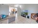 Cozy living room with tile floors, TV and entertainment center, and a comfortable gray sofa at 3160 Santa Cruz Dr, Kissimmee, FL 34746
