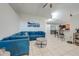 Comfortable living room featuring a large blue sectional sofa and a concrete coffee table at 3160 Santa Cruz Dr, Kissimmee, FL 34746