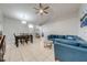 Bright and airy living room with tile floors, a ceiling fan, and a blue sectional at 3160 Santa Cruz Dr, Kissimmee, FL 34746