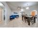 Spacious living room features a blue sofa, tile flooring, and an archway to other rooms at 3160 Santa Cruz Dr, Kissimmee, FL 34746