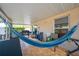 Covered porch with a hammock, grill, and tiled floor perfect for outdoor relaxation at 3160 Santa Cruz Dr, Kissimmee, FL 34746