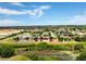 Aerial view of houses on a street with a pond in the background at 318 Highland Meadows Dr, Davenport, FL 33837