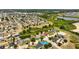 A high-angle view of a residential area near a pond, showcasing the neighborhood's layout and landscaping at 318 Highland Meadows Dr, Davenport, FL 33837