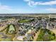 An aerial view of the neighborhood, showcasing houses and local amenities in the distance at 318 Highland Meadows Dr, Davenport, FL 33837