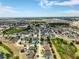 A beautiful aerial view of the residential community, featuring tree-lined streets and blue skies at 318 Highland Meadows Dr, Davenport, FL 33837