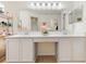 Bathroom featuring dual sinks, framed mirror, and elegant decor at 318 Highland Meadows Dr, Davenport, FL 33837