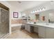 Bathroom featuring double vanity, shower, bathtub, tile floors, modern lighting and decorative accents at 318 Highland Meadows Dr, Davenport, FL 33837