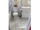 Close up of a bathroom featuring marble tiling, stylish fixtures, and decorative accents around the toilet and vanity at 318 Highland Meadows Dr, Davenport, FL 33837