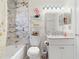 Cozy bathroom featuring marble tiling, stylish fixtures, and decorative accents around the toilet and vanity at 318 Highland Meadows Dr, Davenport, FL 33837