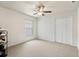 Standard bedroom with neutral colored carpet and walls, featuring a standard closet and natural light at 318 Highland Meadows Dr, Davenport, FL 33837