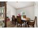 Dining room with modern chandelier, wood flooring and room for six chairs at 318 Highland Meadows Dr, Davenport, FL 33837