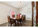 Dining room featuring elegant chandelier, six chairs, and dark wood flooring at 318 Highland Meadows Dr, Davenport, FL 33837