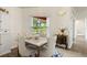 Well-lit dining room with stylish decor and view of the greenery outside at 318 Highland Meadows Dr, Davenport, FL 33837