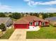 A beautiful one-story home has a well-kept lawn and a convenient attached garage, perfect for suburban living at 318 Highland Meadows Dr, Davenport, FL 33837