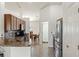 Well-lit kitchen with modern appliances and dark wood flooring at 318 Highland Meadows Dr, Davenport, FL 33837