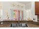 Bright kitchen featuring a stainless steel double sink and marble countertops with decorative floral wall accents at 318 Highland Meadows Dr, Davenport, FL 33837