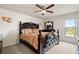 Elegantly styled main bedroom with ceiling fan and a view to the outside at 318 Highland Meadows Dr, Davenport, FL 33837