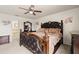 Luxurious main bedroom suite with decorative carved dark wood bed frame and an en suite bathroom at 318 Highland Meadows Dr, Davenport, FL 33837