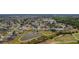 Expansive aerial view of a community with lush trees, ponds, and winding streets, with various homes and manicured lawns at 3256 Countryside View Dr, St Cloud, FL 34772