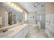 Elegant bathroom with double sinks, a soaking tub, and a separate glass shower at 3256 Countryside View Dr, St Cloud, FL 34772