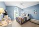Comfortable bedroom with a large window, a ceiling fan, and neutral decor at 3256 Countryside View Dr, St Cloud, FL 34772