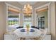 Bright breakfast nook features banquette seating, white table and beautiful pool views at 3256 Countryside View Dr, St Cloud, FL 34772
