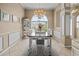 Dining room with large window, chandelier, tile floors and wainscoting at 3256 Countryside View Dr, St Cloud, FL 34772