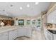 Open kitchen with white cabinets, stainless appliances and breakfast nook overlooking the pool at 3256 Countryside View Dr, St Cloud, FL 34772