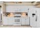Bright kitchen with white cabinets, tile backsplash, and stainless steel appliances at 3256 Countryside View Dr, St Cloud, FL 34772