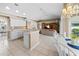 Open kitchen with white cabinets and an eat-in counter that flows to the breakfast nook and living room at 3256 Countryside View Dr, St Cloud, FL 34772