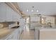 Bright kitchen features white cabinets, tile backsplash and stainless appliances at 3256 Countryside View Dr, St Cloud, FL 34772