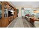 Comfortable living room area with built-in shelving and access to the outdoor area at 3256 Countryside View Dr, St Cloud, FL 34772