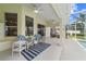 Charming outdoor seating area with ceiling fans and view of the landscaped backyard and screened-in pool at 3256 Countryside View Dr, St Cloud, FL 34772