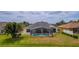 Lovely screened-in pool and backyard space featuring mature landscaping in a well-maintained lawn at 3256 Countryside View Dr, St Cloud, FL 34772