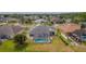 Aerial view of a home with a screened-in pool, green lawn, and beautiful landscaping in a residential neighborhood at 3256 Countryside View Dr, St Cloud, FL 34772