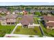 Aerial view of the home, backyard with patio, white fence, and the neighborhood's lake and surrounding houses at 3366 Puxton Dr, Orlando, FL 32824