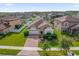 Aerial view of a single Gathering home in a well-maintained neighborhood with green lawns and a brick paver driveway at 3366 Puxton Dr, Orlando, FL 32824