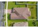 A high-angle aerial view of the home showcasing the roof, backyard, patio, and surrounding greenery at 3366 Puxton Dr, Orlando, FL 32824
