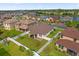 Aerial view featuring the home's backyard with patio, neighborhood, lake, and community surroundings at 3366 Puxton Dr, Orlando, FL 32824