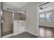 Modern bathroom featuring a glass-enclosed shower with tile surround and wood look tile floors at 3366 Puxton Dr, Orlando, FL 32824