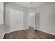 Bedroom with wood-look floors, a ceiling fan and a double-door closet at 3366 Puxton Dr, Orlando, FL 32824