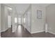 Bright hallway featuring wood flooring and neutral paint, leading to the front door and other rooms at 3366 Puxton Dr, Orlando, FL 32824