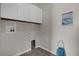 Laundry room with overhead cabinets and access for washer and dryer at 3366 Puxton Dr, Orlando, FL 32824