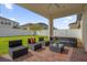 Covered patio with outdoor seating and view of the fenced backyard at 3366 Puxton Dr, Orlando, FL 32824