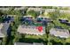 An aerial view of a community with many townhomes, trees, and ample parking at 3426 Wilshire Way Rd # 189, Orlando, FL 32829