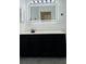 Bathroom vanity with a black cabinet, white countertop, and a modern mirror with built-in lighting at 3426 Wilshire Way Rd # 189, Orlando, FL 32829