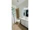 Well-lit bathroom with a shower-tub combo, vanity, and a decorative eucalyptus shower curtain at 3426 Wilshire Way Rd # 189, Orlando, FL 32829