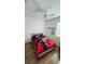 Cozy bedroom with a colorful bedspread, featuring wood-look floors and natural light from the window at 3426 Wilshire Way Rd # 189, Orlando, FL 32829