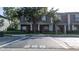 Townhome exterior featuring reserved parking spot, well-kept lawns, and mature trees at 3426 Wilshire Way Rd # 189, Orlando, FL 32829